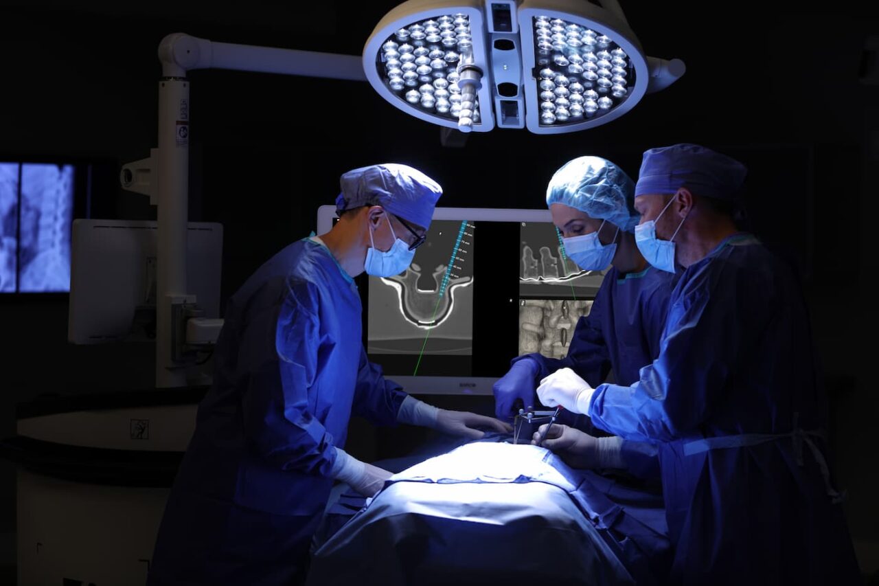 Surgeons operating on a patient with 7D surgical system